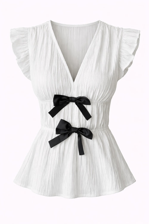 White pleated top with black bows on a white background