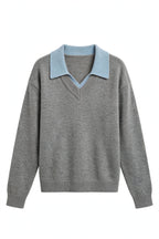 A gray knit sweater with a contrasting light blue v-neck collar, shown against a plain white background.