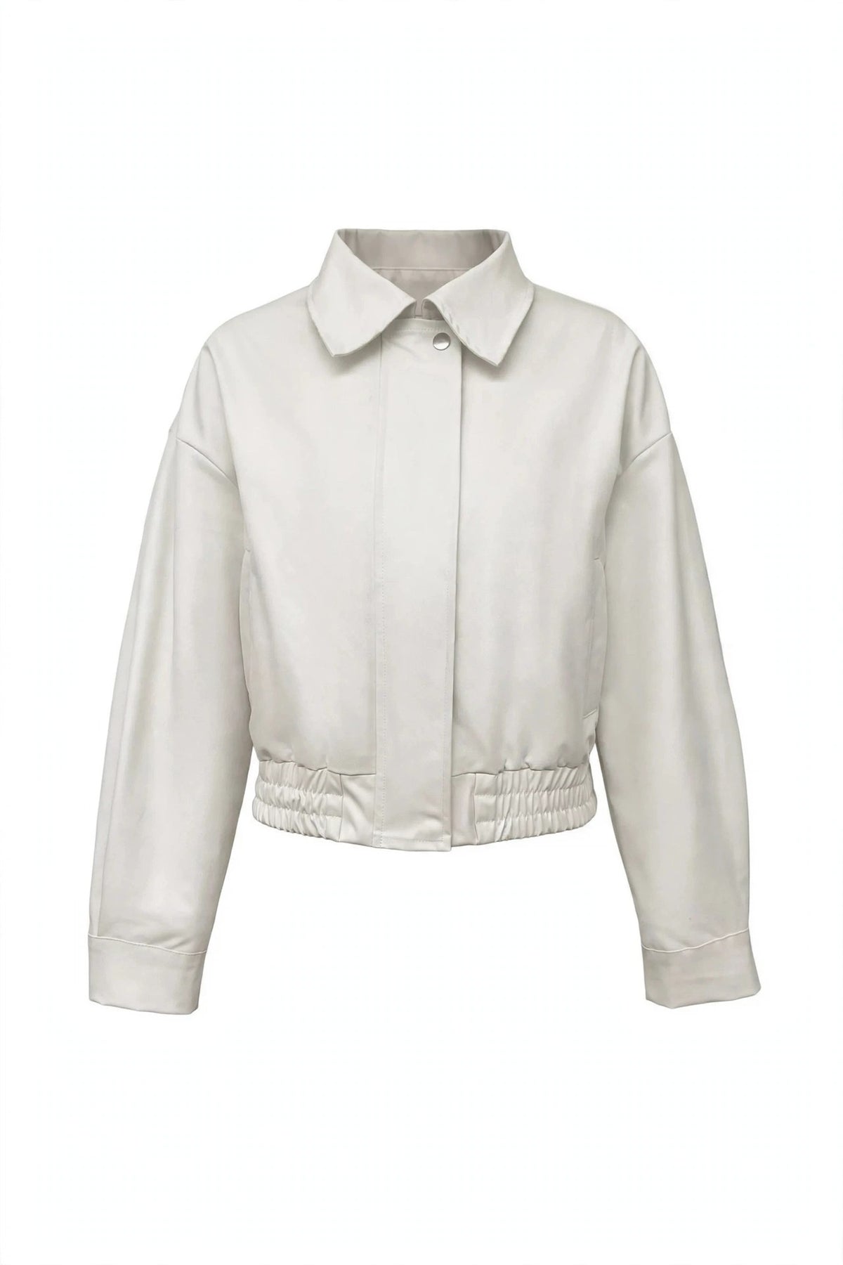 A cropped, long-sleeve jacket in a light cream or off-white color, featuring a pointed collar, button front, and elasticized gathered waist, shown against a plain white background.